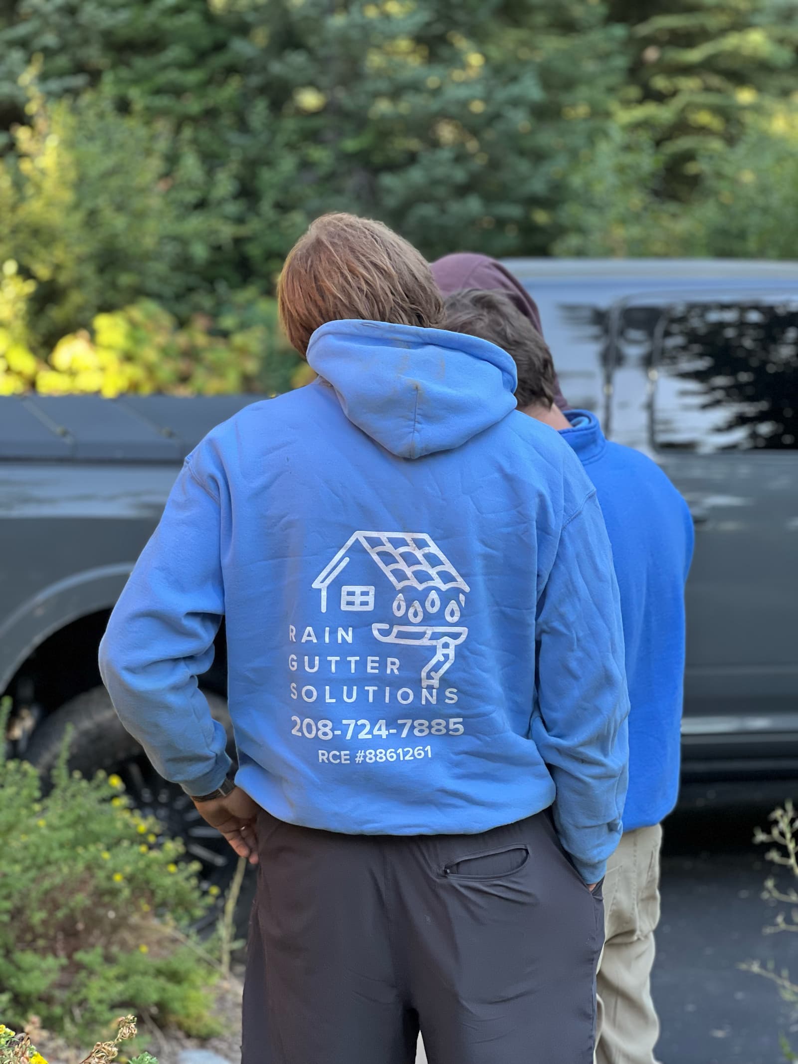 Company hoodie carrying the Rain Gutter Solutions logo, the office number and Idaho registration RCE-8861261