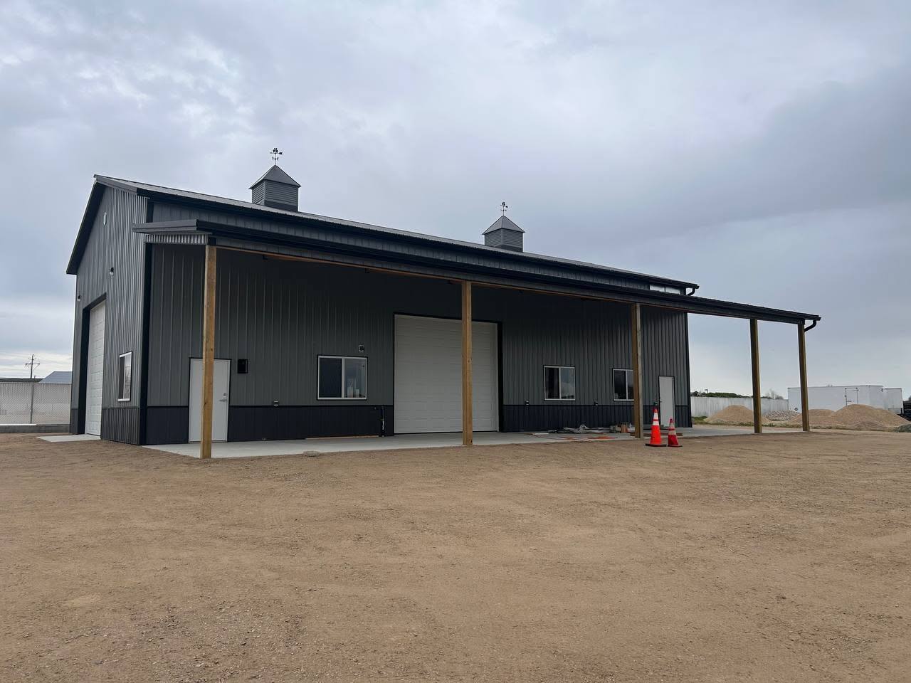 Gutter and oversized downspout on a large steel commercial building