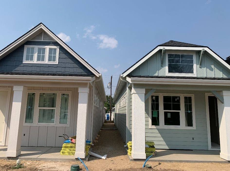 Two new craftsman homes side by side with matching gutter work