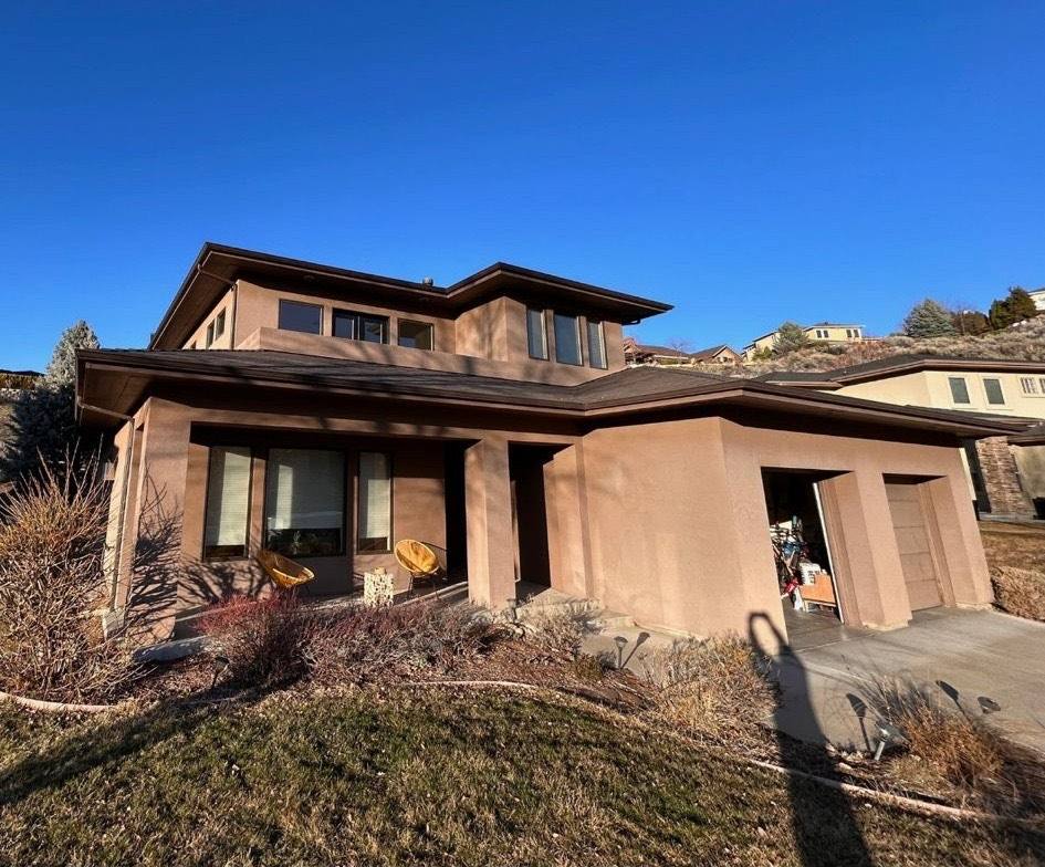 Seamless gutter across the roofline of a modern brown Idaho home