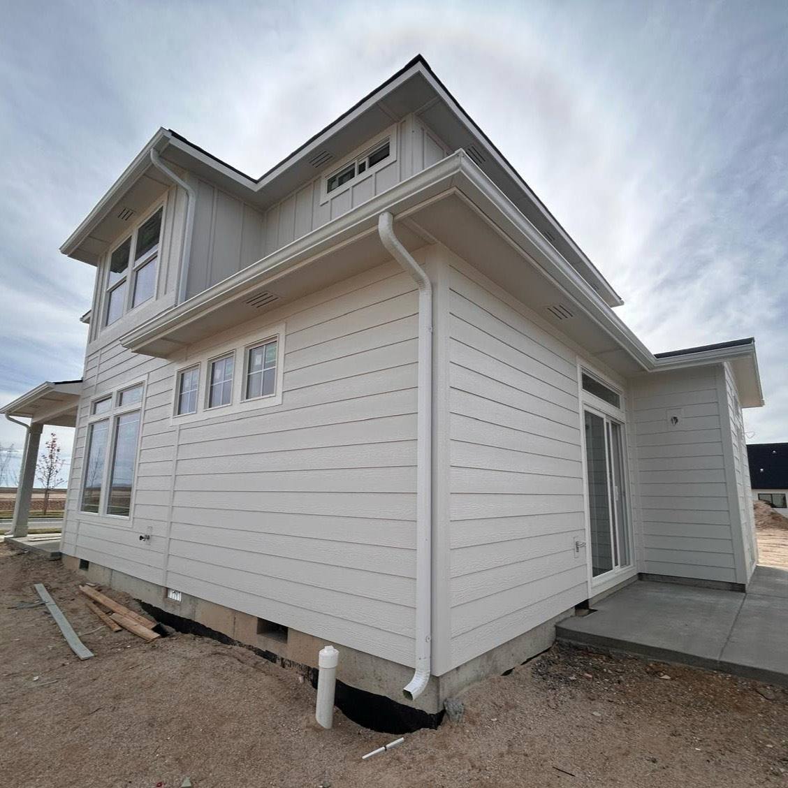 Downspout and seamless gutter on a modern white Treasure Valley house
